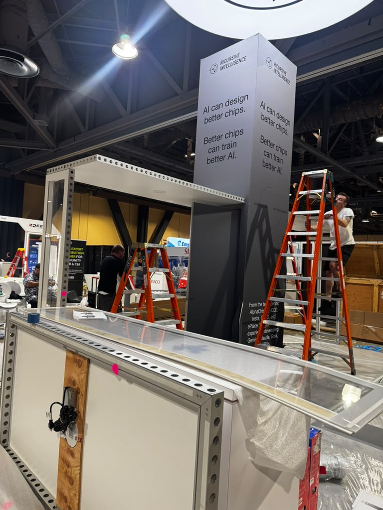 Illuminated circular overhead hanging sign installed above custom trade show booth at convention center, rigged and installed by Elevate Exhibits team.