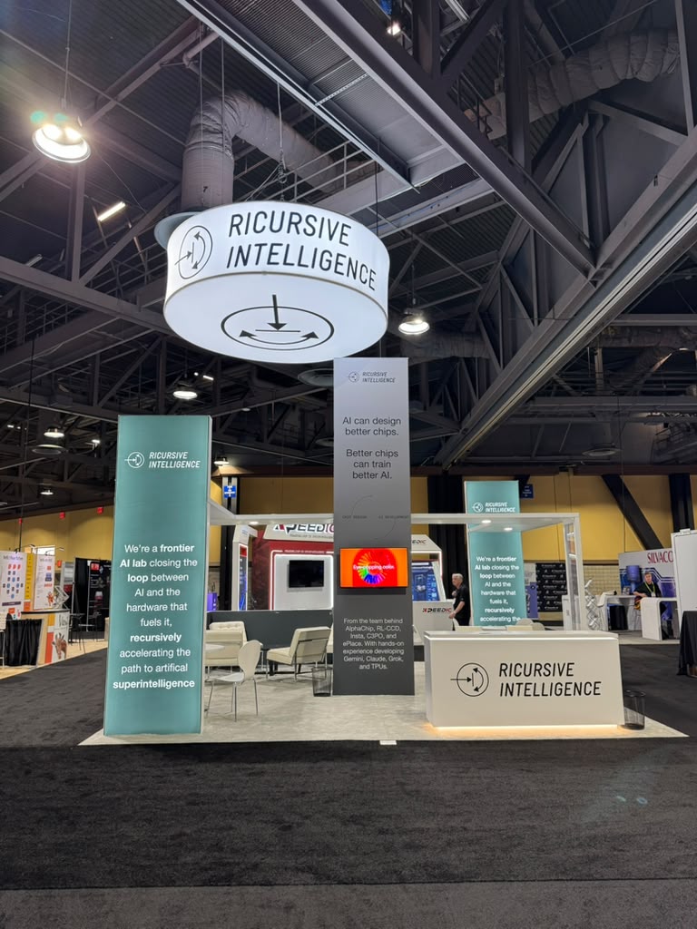 Completed custom island trade show booth for Ricursive Intelligence at DAC 2026 Long Beach Convention Center, designed and built by Elevate Exhibits.
